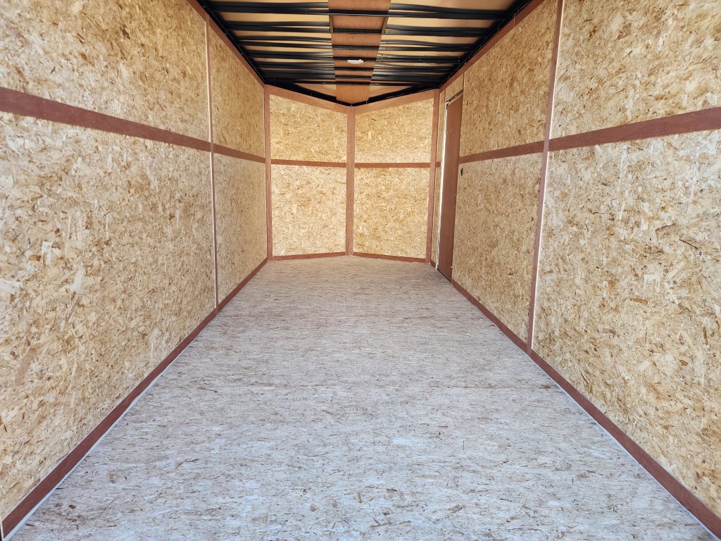 Un long couloir avec un sol recouvert de moquette et des murs en bois